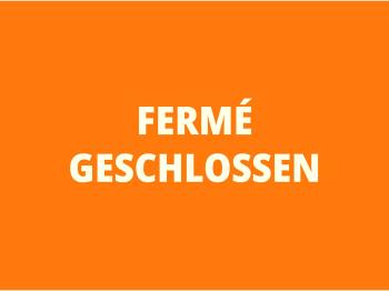 Fermé - Geschlossen écrit en blanc sur fond orange